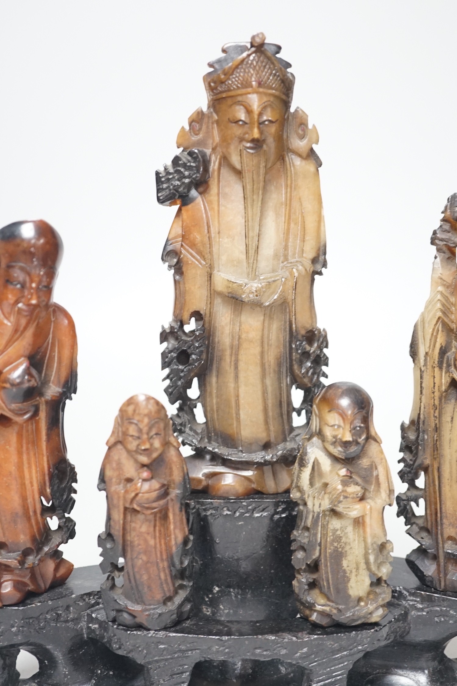 An early 20th century Chinese carved soapstone group of five deities on a rockwork base, 23cm